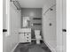 Updated bathroom featuring a modern vanity, floating shelves, and tiled shower with glass door at 724 Merridale Dr, Charlotte, NC 28214
