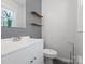 Cozy bathroom featuring a modern vanity, mirror, and toilet at 724 Merridale Dr, Charlotte, NC 28214
