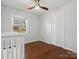 Cozy bedroom with wood floors, a ceiling fan, and a view to the backyard at 724 Merridale Dr, Charlotte, NC 28214