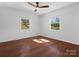 Bright bedroom with hardwood floors, a ceiling fan, and two windows offering natural light at 724 Merridale Dr, Charlotte, NC 28214
