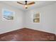 Inviting bedroom with hardwood floors, white walls, and natural light from two windows at 724 Merridale Dr, Charlotte, NC 28214