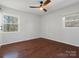 Well-lit bedroom featuring wood floors and natural light from dual windows at 724 Merridale Dr, Charlotte, NC 28214