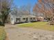 Charming brick house featuring a well-manicured lawn and a paved driveway at 724 Merridale Dr, Charlotte, NC 28214