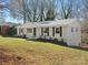 Well-maintained brick house featuring a gray roof and a lush green lawn at 724 Merridale Dr, Charlotte, NC 28214
