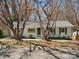 Charming brick home with dark shutters and a beautifully landscaped front yard at 724 Merridale Dr, Charlotte, NC 28214