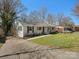 Lovely brick home with dark shutters, a well-kept lawn, and a paved driveway at 724 Merridale Dr, Charlotte, NC 28214