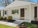 Inviting front porch featuring a brick facade and dark trim at 724 Merridale Dr, Charlotte, NC 28214