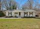 Charming single story home with fresh landscaping and a well-maintained lawn at 724 Merridale Dr, Charlotte, NC 28214