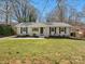 Charming single story home with fresh landscaping and a well-maintained lawn at 724 Merridale Dr, Charlotte, NC 28214