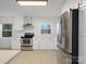 Bright kitchen features white cabinets, stainless steel appliances, and modern finishes at 724 Merridale Dr, Charlotte, NC 28214