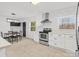 Eat-in kitchen features white cabinets, stainless steel appliances, and an island at 724 Merridale Dr, Charlotte, NC 28214