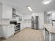 Bright kitchen features white cabinets, stainless steel appliances, and modern finishes at 724 Merridale Dr, Charlotte, NC 28214