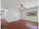 Bright living room featuring a ceiling fan, wood floors, and a large window at 724 Merridale Dr, Charlotte, NC 28214