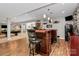 Basement wet bar featuring dark wood cabinets, countertop seating, and a mini fridge at 7343 Mill Ruins Sw Ave, Concord, NC 28025