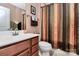 Stylish bathroom with a wood vanity and decorative shower curtain at 7343 Mill Ruins Sw Ave, Concord, NC 28025