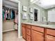 En suite bathroom with a double vanity, and a walk-in closet to the left at 7343 Mill Ruins Sw Ave, Concord, NC 28025
