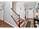 Inviting foyer with hardwood floors, staircase, and elegant decor at 7343 Mill Ruins Sw Ave, Concord, NC 28025