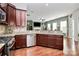 Modern kitchen with granite counters and open view to the living room at 7343 Mill Ruins Sw Ave, Concord, NC 28025