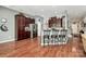 Kitchen with stainless steel appliances, dark wood cabinets, bar seating, and hardwood floors at 7343 Mill Ruins Sw Ave, Concord, NC 28025