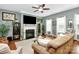 Comfortable living room with fireplace, ceiling fan and plenty of seating at 7343 Mill Ruins Sw Ave, Concord, NC 28025