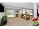 An open living room space featuring light gray walls, neutral toned furniture, and large windows with natural light at 7343 Mill Ruins Sw Ave, Concord, NC 28025
