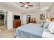 Main bedroom with a tray ceiling, ceiling fan, a walk-in closet and a view into the en suite bathroom at 7343 Mill Ruins Sw Ave, Concord, NC 28025