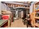 Unfinished basement space with exposed beams, ductwork, and a small workshop area at 7343 Mill Ruins Sw Ave, Concord, NC 28025