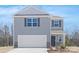 Two story home with gray siding, white trim, shutters, a two car garage, and stone accents at 808 N Naughton St, Chester, SC 29706