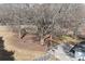 An aerial view of a home with a basketball court, large trees, and yard with winter grass at 934 W Nc 150 Hwy, Lincolnton, NC 28092