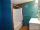 A bathroom with a shower-tub combo, white vanity, and blue and brown walls at 934 W Nc 150 Hwy, Lincolnton, NC 28092