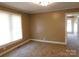 A bedroom with neutral walls, carpet, and windows that allows natural light to brighten the room at 934 W Nc 150 Hwy, Lincolnton, NC 28092