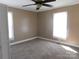 A bedroom featuring neutral walls, carpet, and two windows providing natural light at 934 W Nc 150 Hwy, Lincolnton, NC 28092