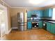 A kitchen with stainless steel refrigerator and blue cabinets with tile backsplash at 934 W Nc 150 Hwy, Lincolnton, NC 28092