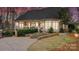 Exterior view of a home with a well-manicured lawn, stone steps, and back porch at 1025 Seminole Dr, Waxhaw, NC 28173