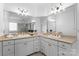 Bathroom with white cabinets, dual sinks, a large mirror, and tile floors at 1025 Seminole Dr, Waxhaw, NC 28173