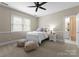 Bedroom with neutral carpet and a bed, and an adjoining bathroom at 1025 Seminole Dr, Waxhaw, NC 28173