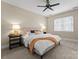 Carpeted bedroom features a ceiling fan, natural light, and bedside tables with lamps at 1025 Seminole Dr, Waxhaw, NC 28173