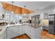 Kitchen featuring white cabinets, granite counters, hardwood floors, and wood plank ceiling at 1025 Seminole Dr, Waxhaw, NC 28173