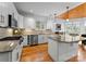 Spacious kitchen with granite countertops, white cabinets, hardwood floors, and stainless appliances at 1025 Seminole Dr, Waxhaw, NC 28173