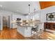 Bright kitchen with white cabinets, granite counters, hardwood floors, and breakfast bar at 1025 Seminole Dr, Waxhaw, NC 28173