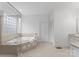 Main bathroom featuring a large soaking tub with glass shower and white cabinets at 1025 Seminole Dr, Waxhaw, NC 28173