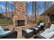 A stunning outdoor fireplace with wicker seating and beautiful stonework accents at 1025 Seminole Dr, Waxhaw, NC 28173