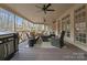 Covered porch with outdoor furniture, ceiling fans, and a grill for entertaining at 1025 Seminole Dr, Waxhaw, NC 28173