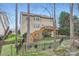Backyard featuring multiple decks, stairs, a fence, and grass at 1005 Forbishire Dr, Matthews, NC 28104