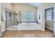 Bright bathroom with a soaking tub, a separate shower, and tile flooring, offering a spa-like experience at 1005 Forbishire Dr, Matthews, NC 28104