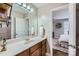 Bathroom with a vanity, large mirror, view into bedroom, and updated features at 1005 Forbishire Dr, Matthews, NC 28104
