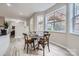 Dining area with natural light featuring a round wooden table set and large windows at 1005 Forbishire Dr, Matthews, NC 28104