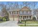 Beautiful two-story brick home featuring an attached two-car garage and a welcoming front porch at 1005 Forbishire Dr, Matthews, NC 28104