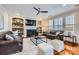 Inviting living room with a fireplace, built-in shelving, and comfortable seating arrangement, perfect for relaxation and entertainment at 1005 Forbishire Dr, Matthews, NC 28104