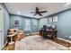 Office room featuring wood floors, an accent wall, a ceiling fan, and natural light at 1005 Forbishire Dr, Matthews, NC 28104
